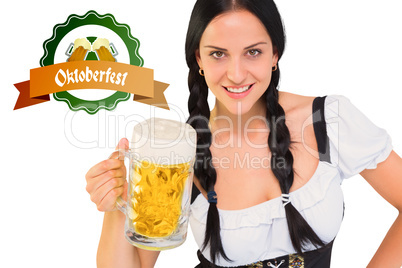 Composite image of pretty oktoberfest girl holding beer tankard