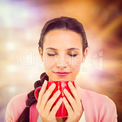 Composite image of pretty brunette holding a mug