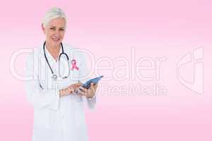 Composite image of smiling female doctor using table computer