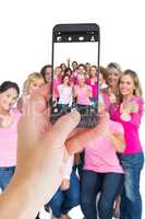 Composite image of female hand holding a smartphone