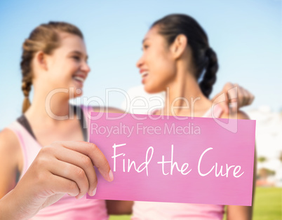 Find the cure against two smiling women wearing pink for breast