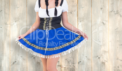 Composite image of oktoberfest girl spreading her skirt