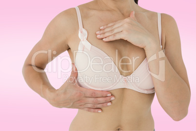 Composite image of woman in bra with breast cancer awareness rib