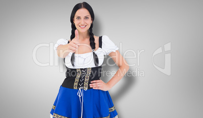 Composite image of pretty oktoberfest girl smiling at camera