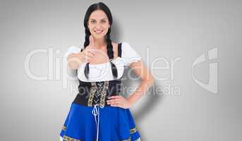 Composite image of pretty oktoberfest girl smiling at camera