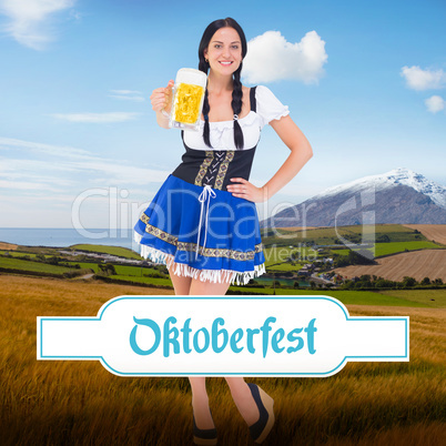 Composite image of pretty oktoberfest girl holding beer tankard