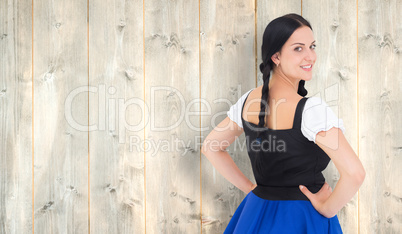 Composite image of pretty oktoberfest girl smiling at camera