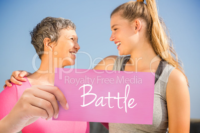 Battle against sporty mother and daughter smiling at each other
