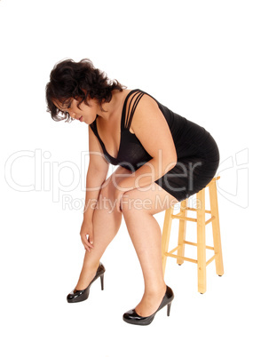 Plus size woman sitting on chair.