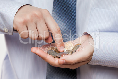 Business man hand holding coin savings counting money profit or