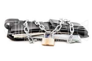 Chain padlock on leather wallet full of dollar currency money