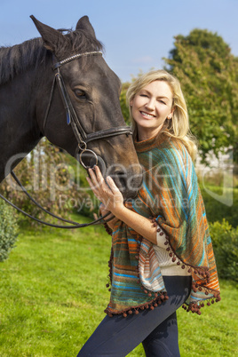 Woman in Poncho Leading Her Horse