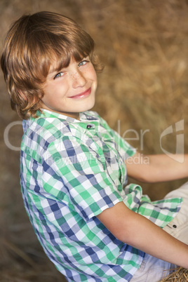 Young Happy Boy Smiling on Hay Bales