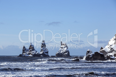 Three pinnacles of Vik with rough waves, South Iceland