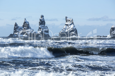 Three pinnacles of Vik with rough waves, South Iceland