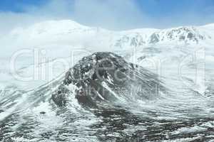 Snow-covered volcanic mountain landscape in Iceland