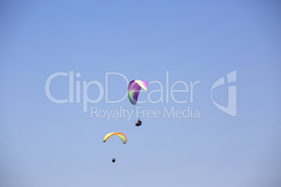 Colorful paragliders with blue sky