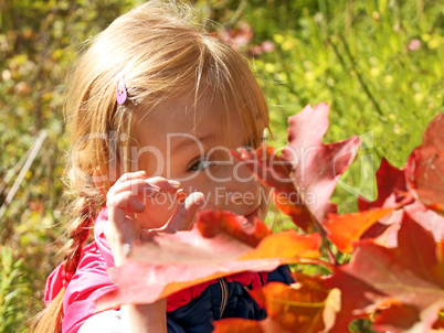 Little girl resting in autumn park