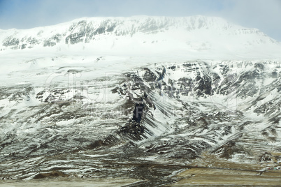 Snow-covered volcanic mountain landscape in Iceland