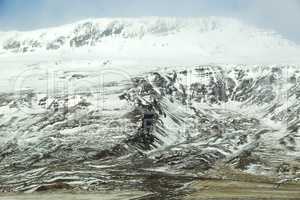 Snow-covered volcanic mountain landscape in Iceland