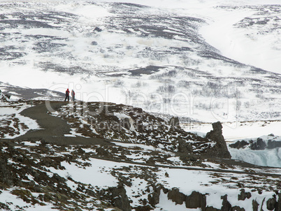 Tourists at the Icelandic waterfall Godafoss in wintertime