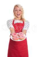Hausfrau in Schürze hält einen Teller Donuts
