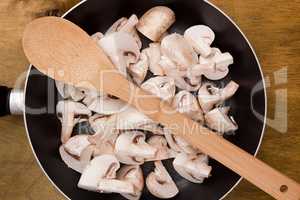 Coarsely chopped mushrooms in a frying pan