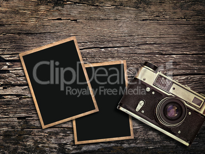 old vintage camera and photos on a wooden background