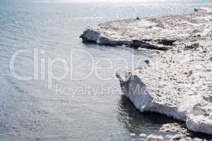 Dirty ice edge and melting floes at water