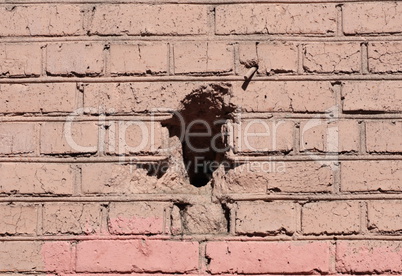 red brick wall background  with black hole