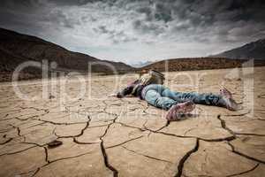 Person lays on the dried ground