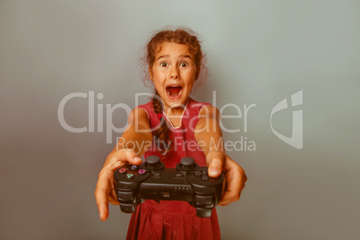 Girl European appearance ten years holding a joystick in his han