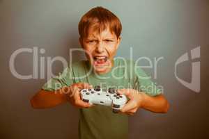 Teen boy screaming open mouth holds the emotions game joystick o