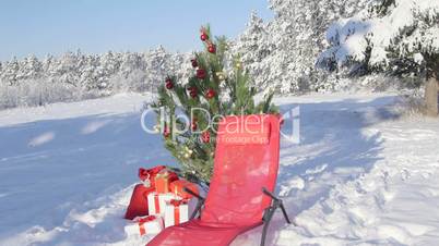Gift bag under Christmas tree in snow covered winter forest