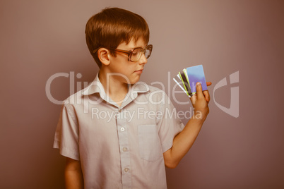 teenager boy brown hair European appearance in sunglasses holdin