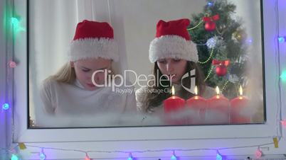 Children with gifted new electronic gadget near Christmas tree