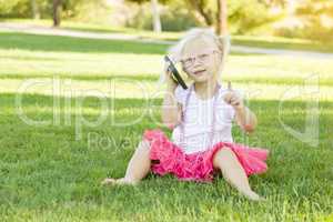 Little Girl In Grass Talking on Cell Phone