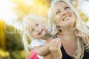 Mother and Little Girl Having Fun Together in Grass