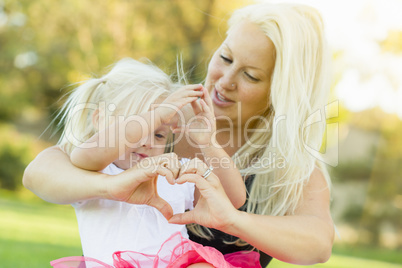 Little Girl With Mother Making Heart Shape with Hands