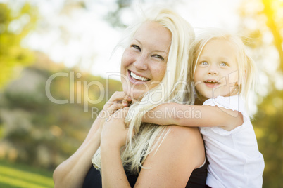 Mother and Little Girl Having Fun Together in Grass