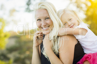 Mother and Little Girl Having Fun Together in Grass