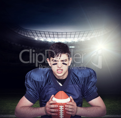 Composite image of enraged american football player holding a ba