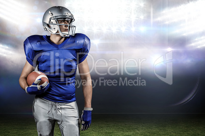 Composite image of confident american football player looking aw