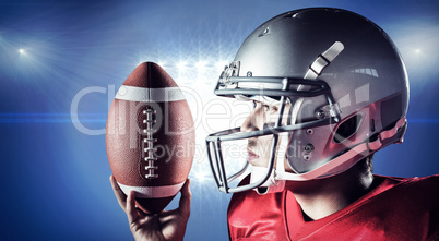 Composite image of confident sportsman looking away while holdin