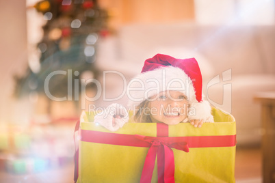 Cute little girl sitting in giant christmas gift