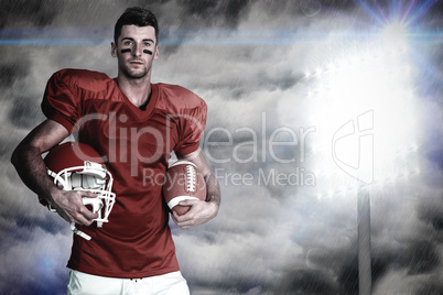 Composite image of portrait of player holding rugby ball and hel