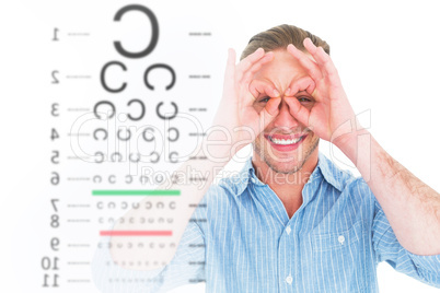 Composite image of smiling doctor forming eyeglasses with his ha