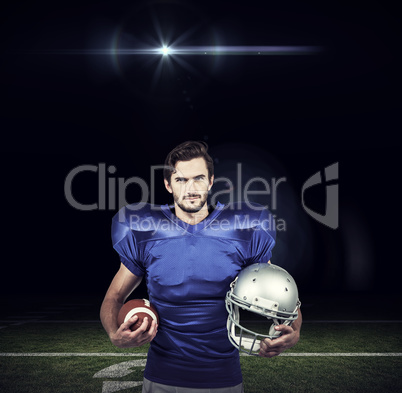 Composite image of confident american football player holding an