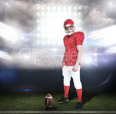 Composite image of serious american football player wearing a he