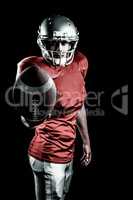 Composite image of confident american football player showing ba